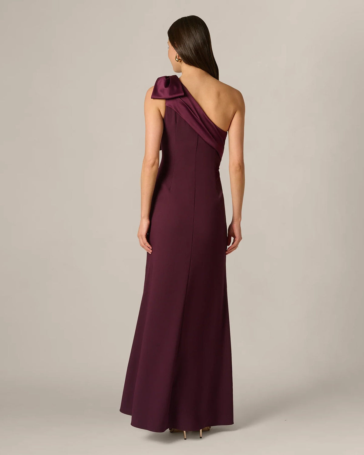 Back view of burgundy wine one-shoulder maxi dress with bow detail