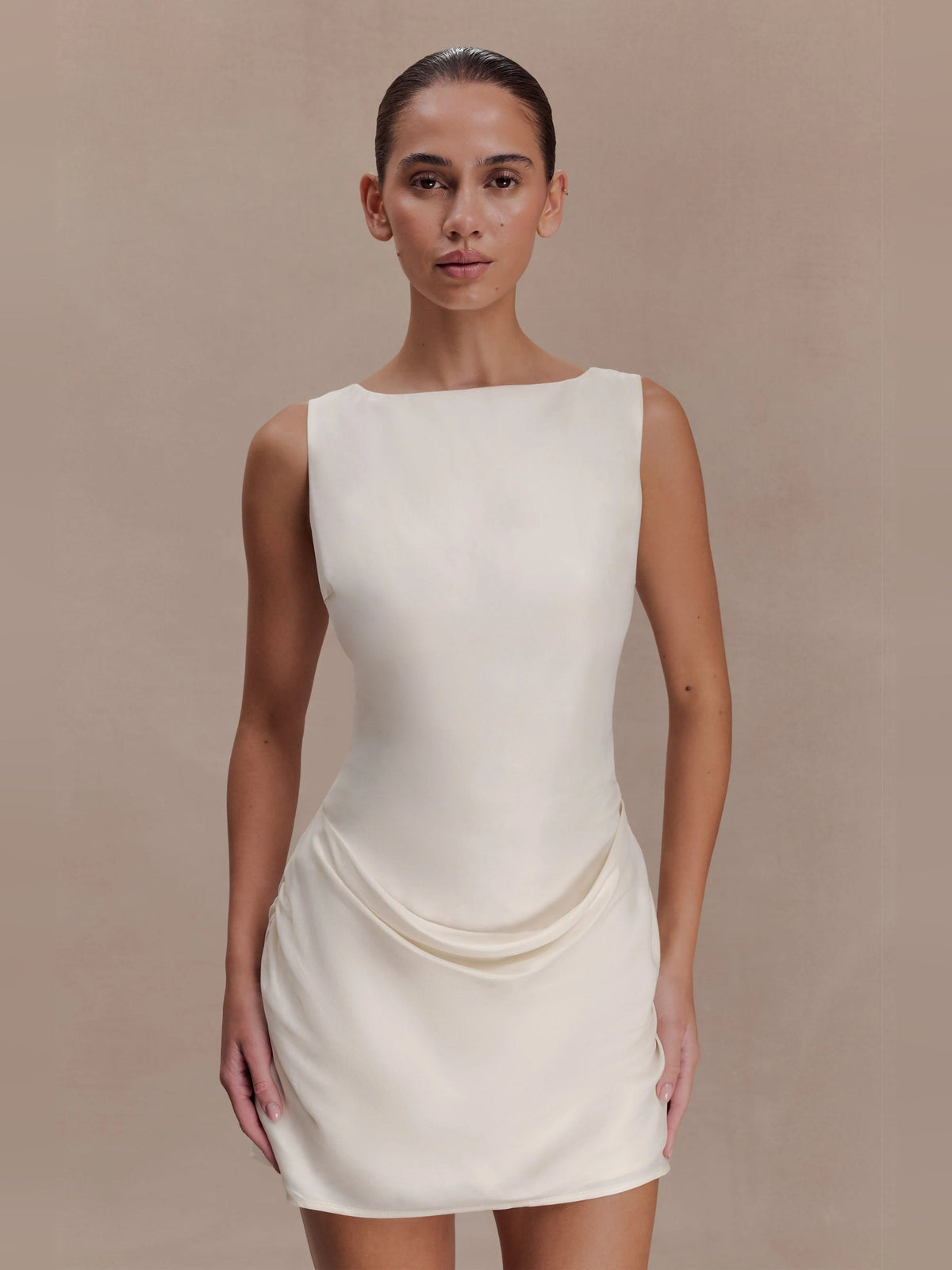 Ivory sleeveless mini dress with draped cowl detail and smooth fitted bodice