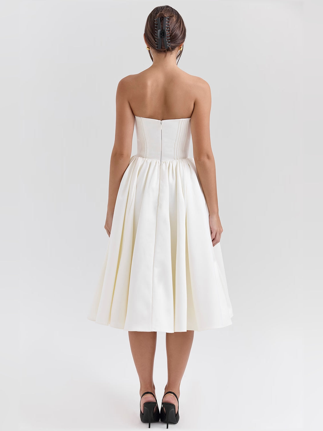 Ivory satin midi dress from back view with strapless bodice and pleated skirt