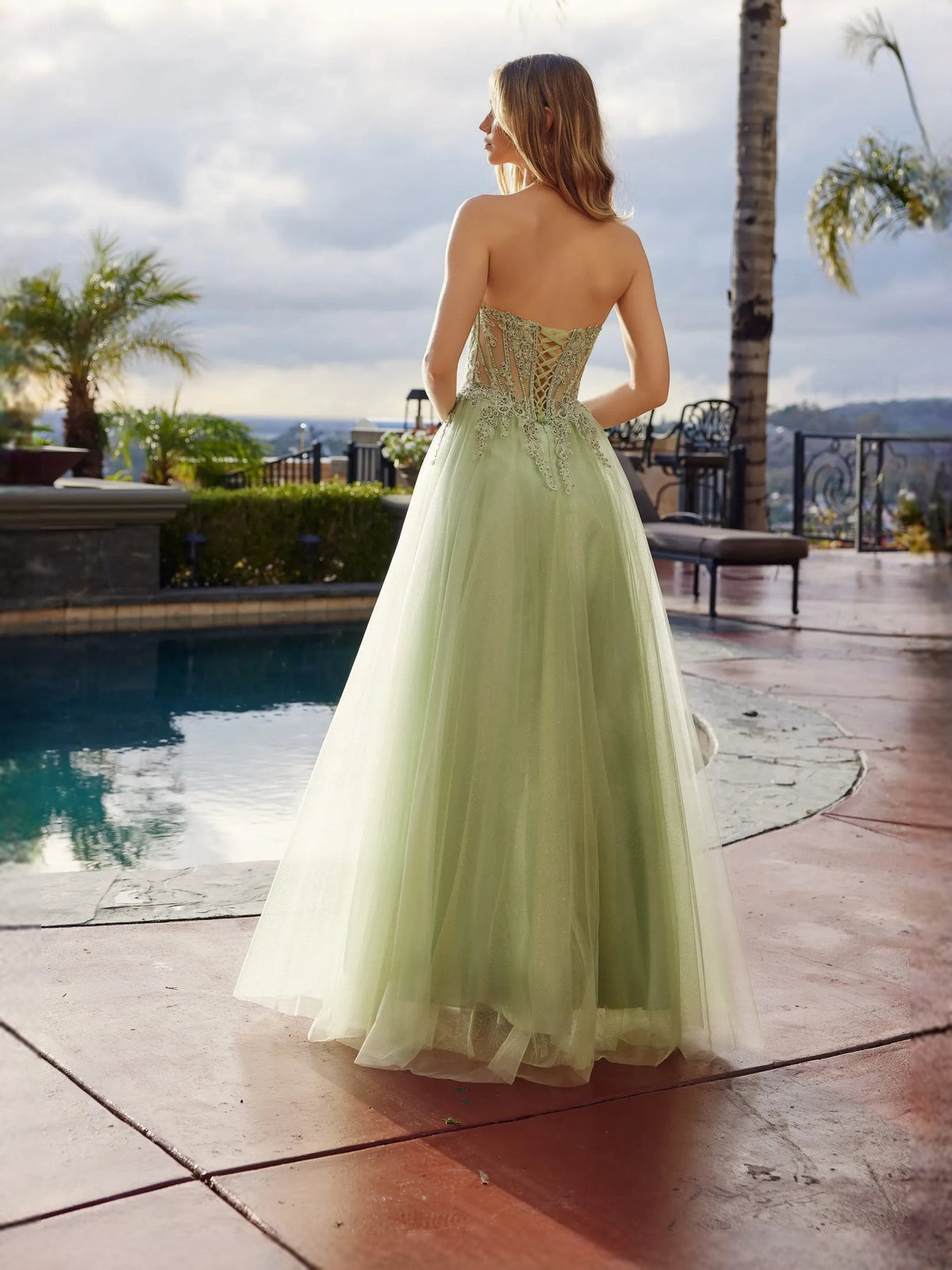 Sage green corset prom dress with floral beadwork, open back, front slit tulle skirt