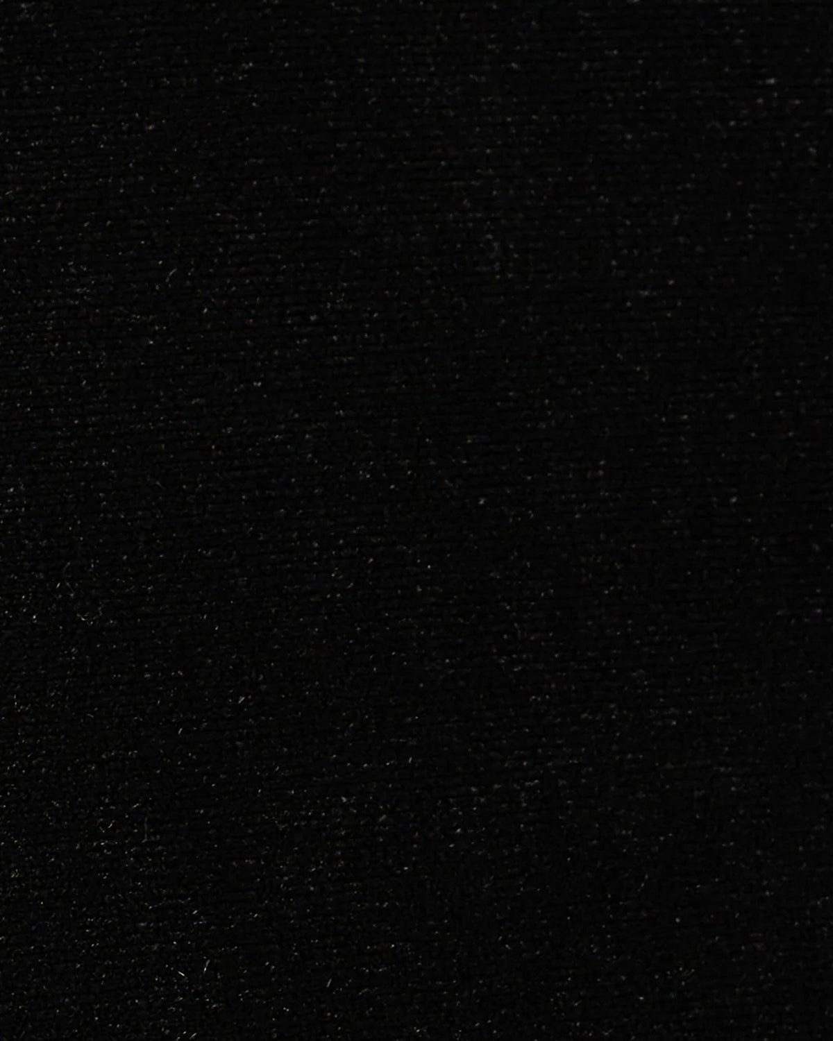 Black textured fabric close-up with fine speckled surface finish
