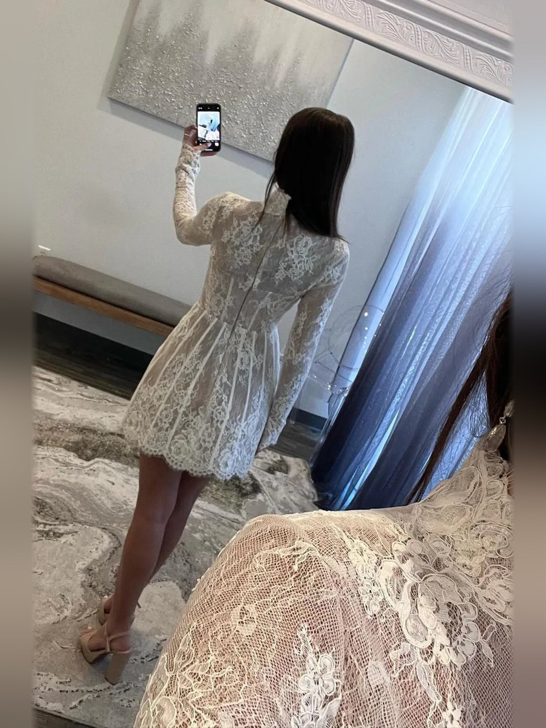 White lace corset mini dress, back view with long sleeves and A-line skirt