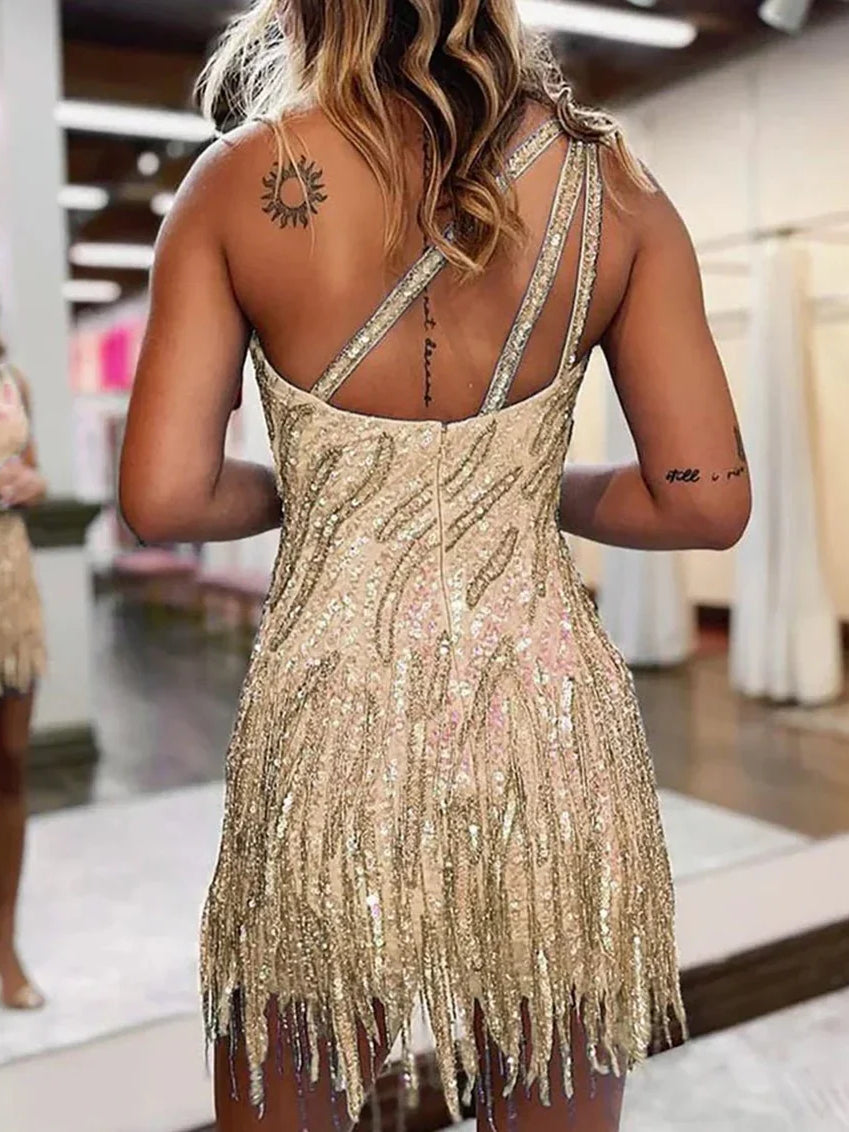 Gold sequin mini dress with one-shoulder look and crisscross open back straps, fringe hem
