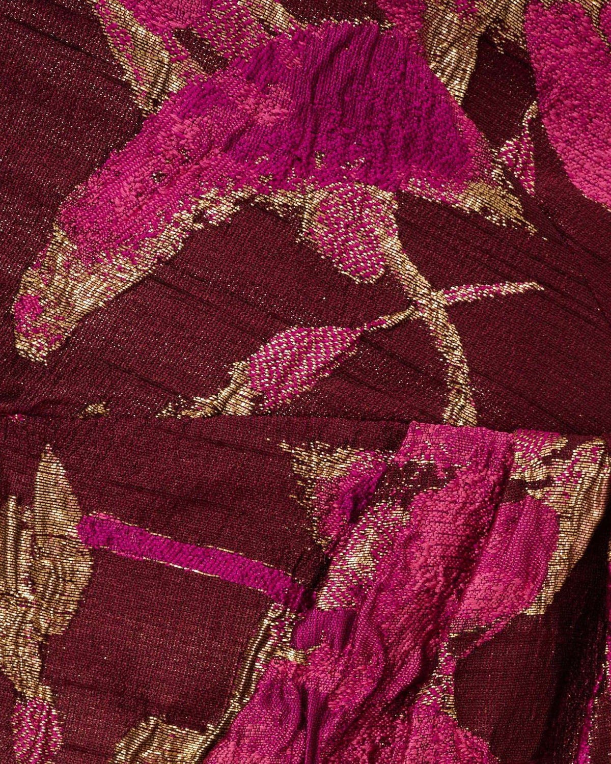 Burgundy and gold glitter-like fabric with magenta botanical pattern texture