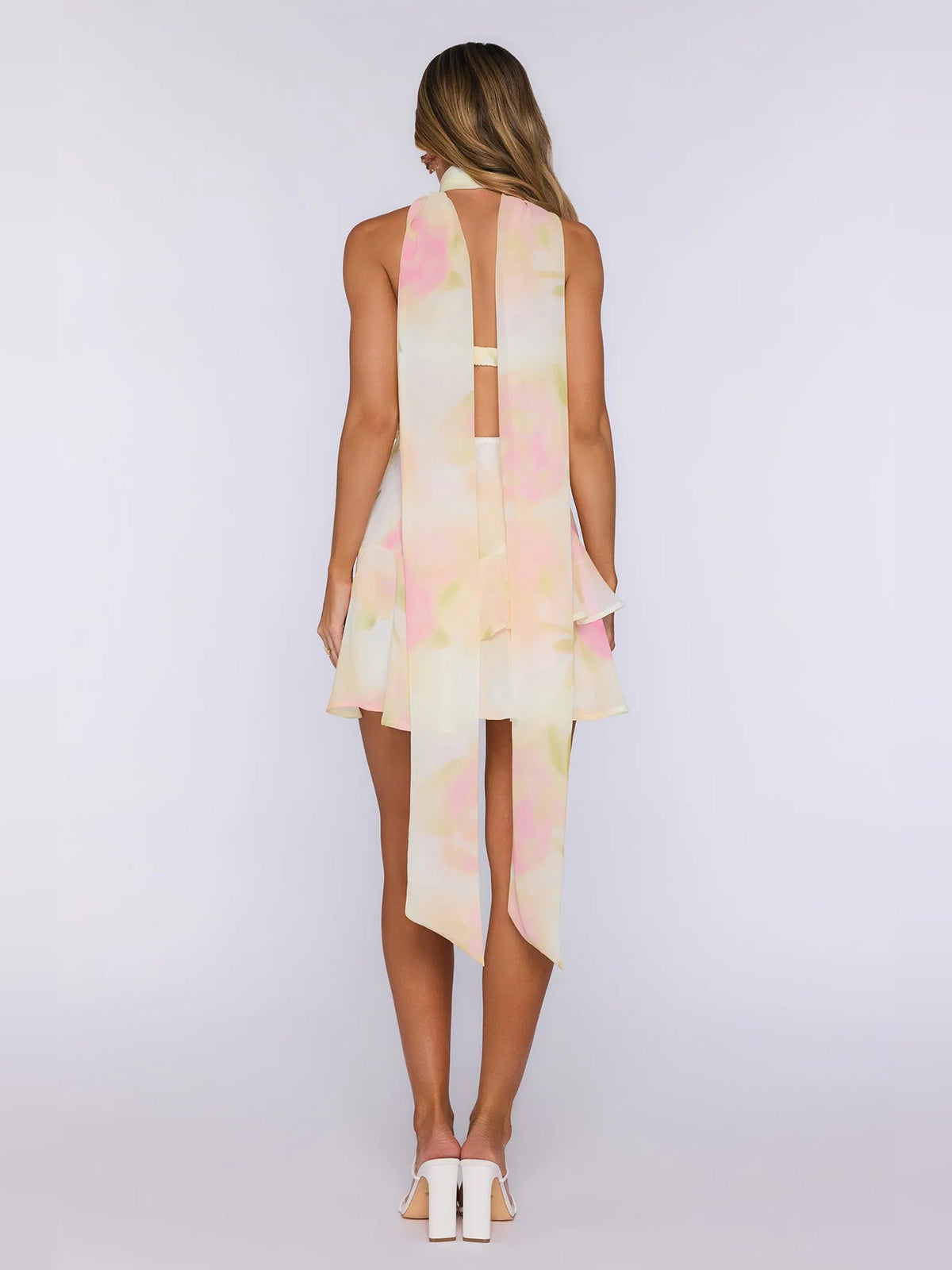 Back view of strapless pastel mini dress with sheer vertical panel and long tie.
