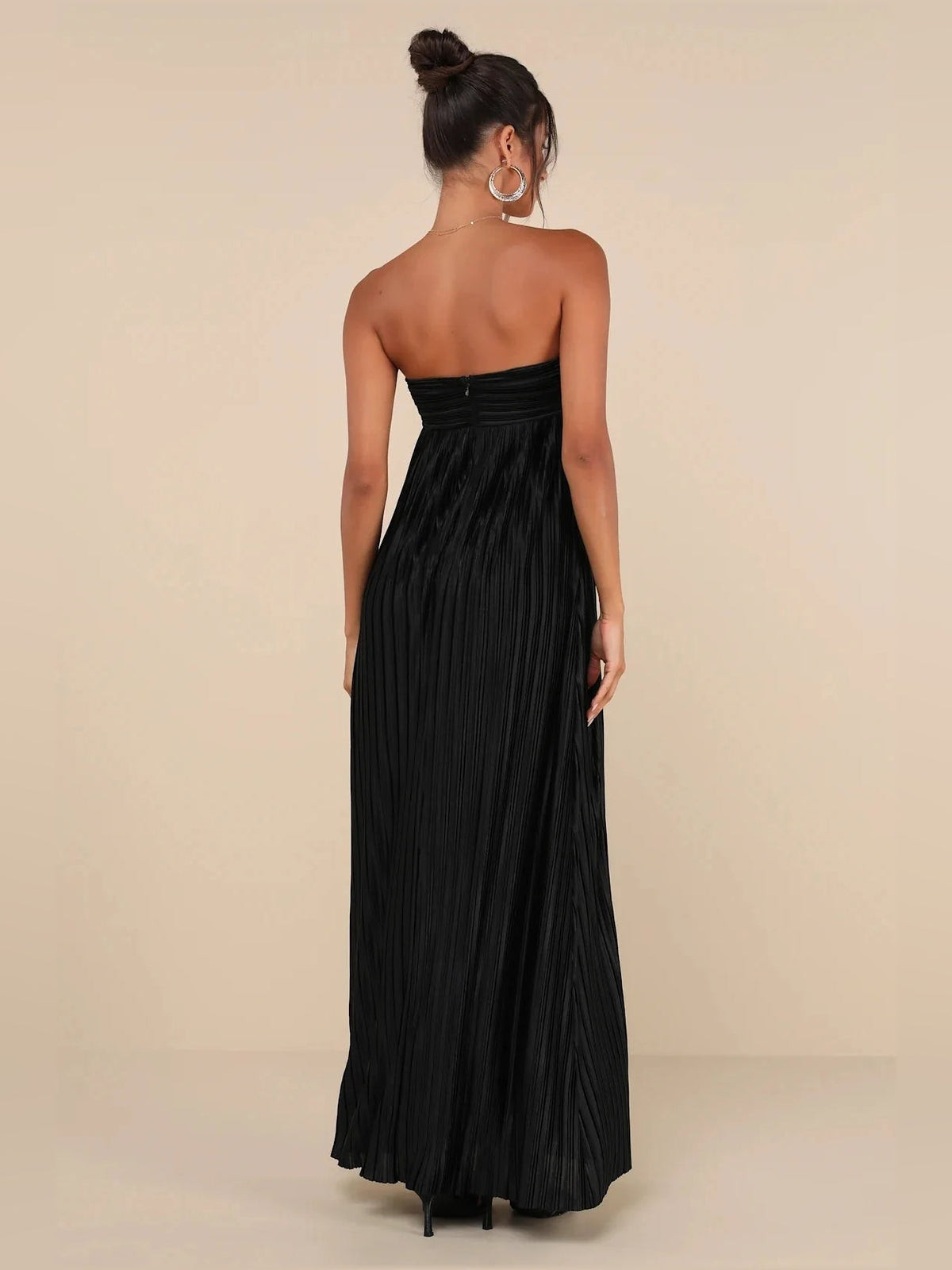 Black strapless satin maxi dress with gathered waistband and pleated skirt, open back