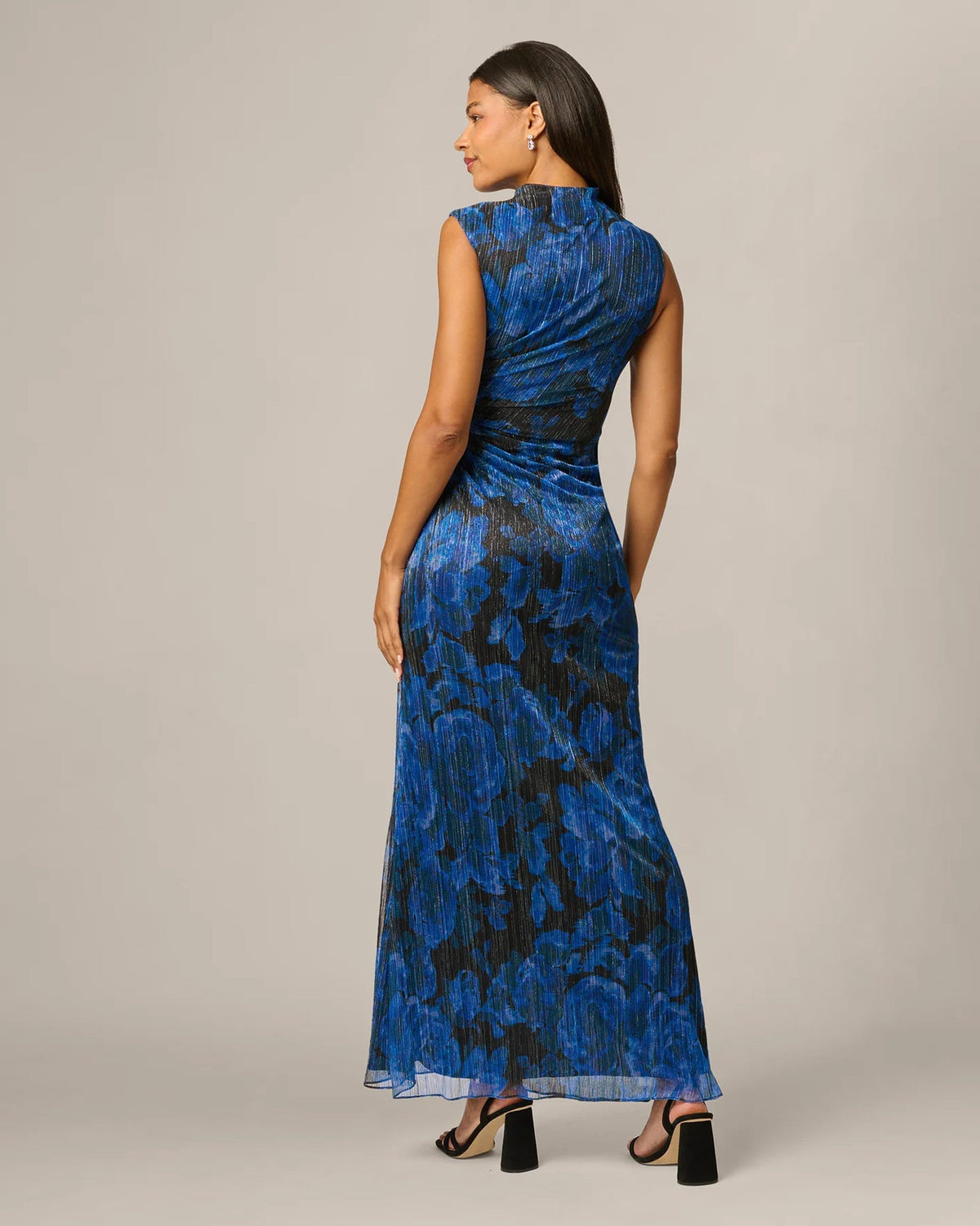Back view of blue and black floral print maxi dress with ruched waist and spaghetti straps