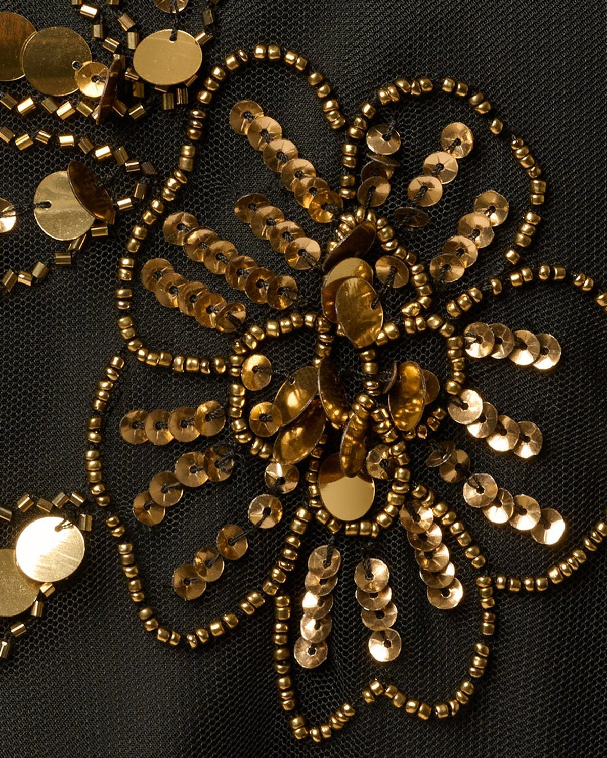 Black fabric with dense gold sequin and bead floral embroidery