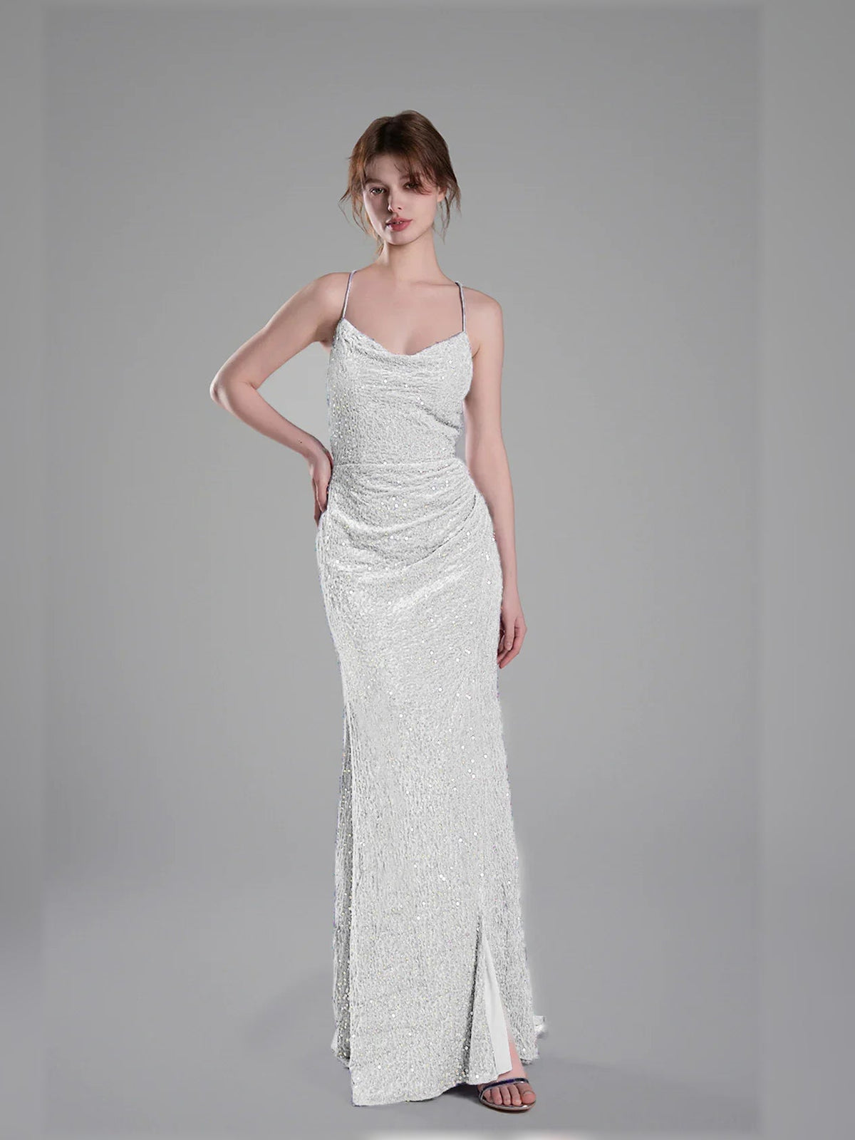 White sequin floor-length formal dress with spaghetti straps and side slit