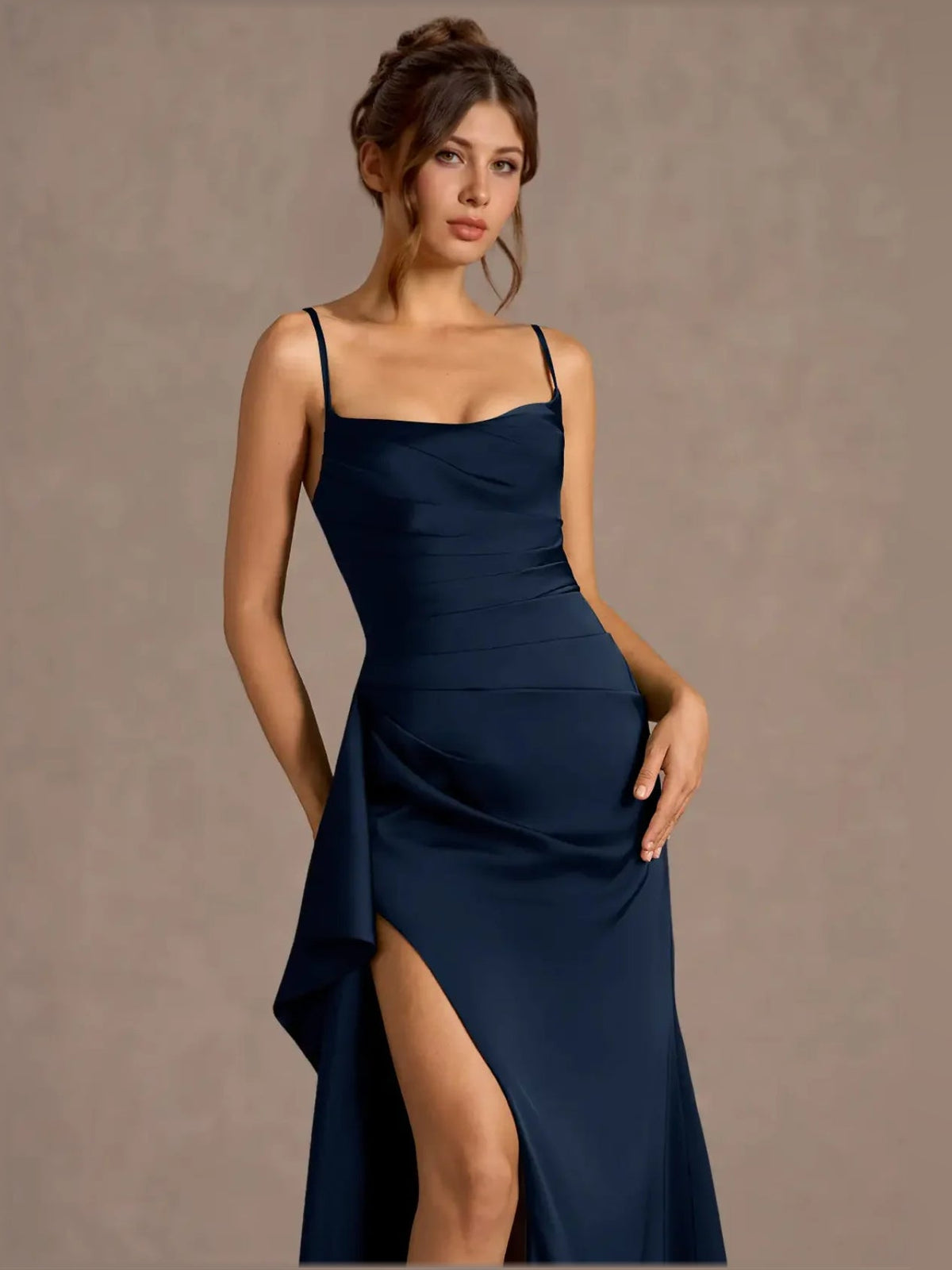 Dark navy sweetheart formal dress with spaghetti straps and draped side slit detail.