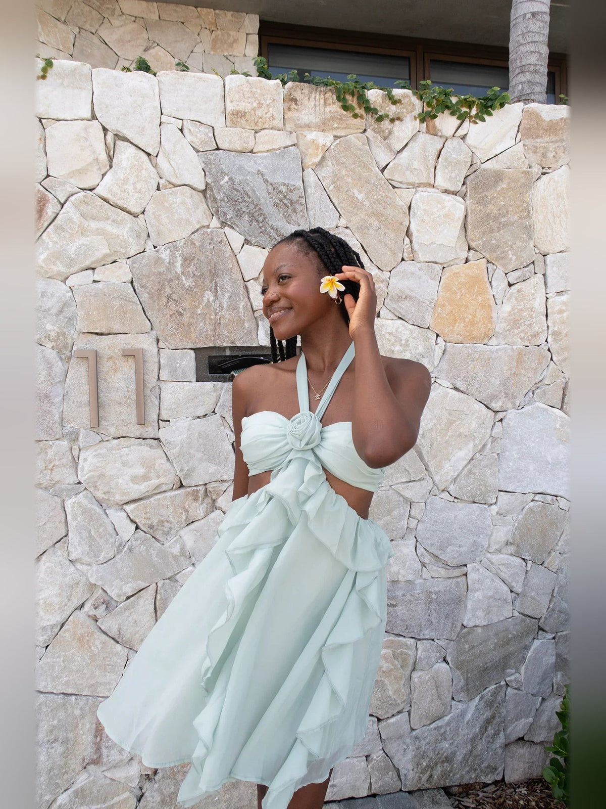 Mint green chiffon homecoming dress with halter bow, ruffled skirt, and flower hair tie