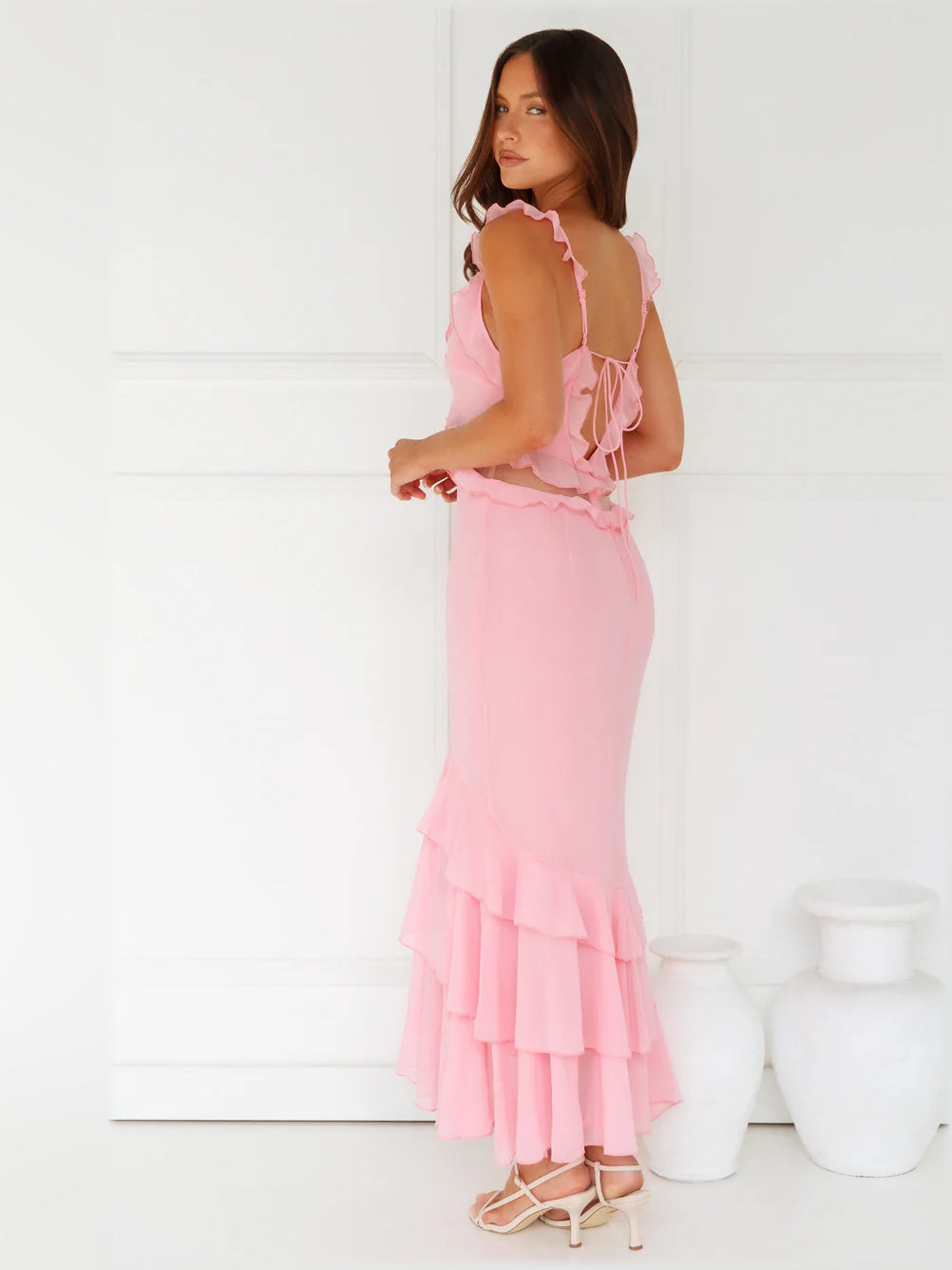 Side view of pink midi formal dress with open-back straps and layered skirt