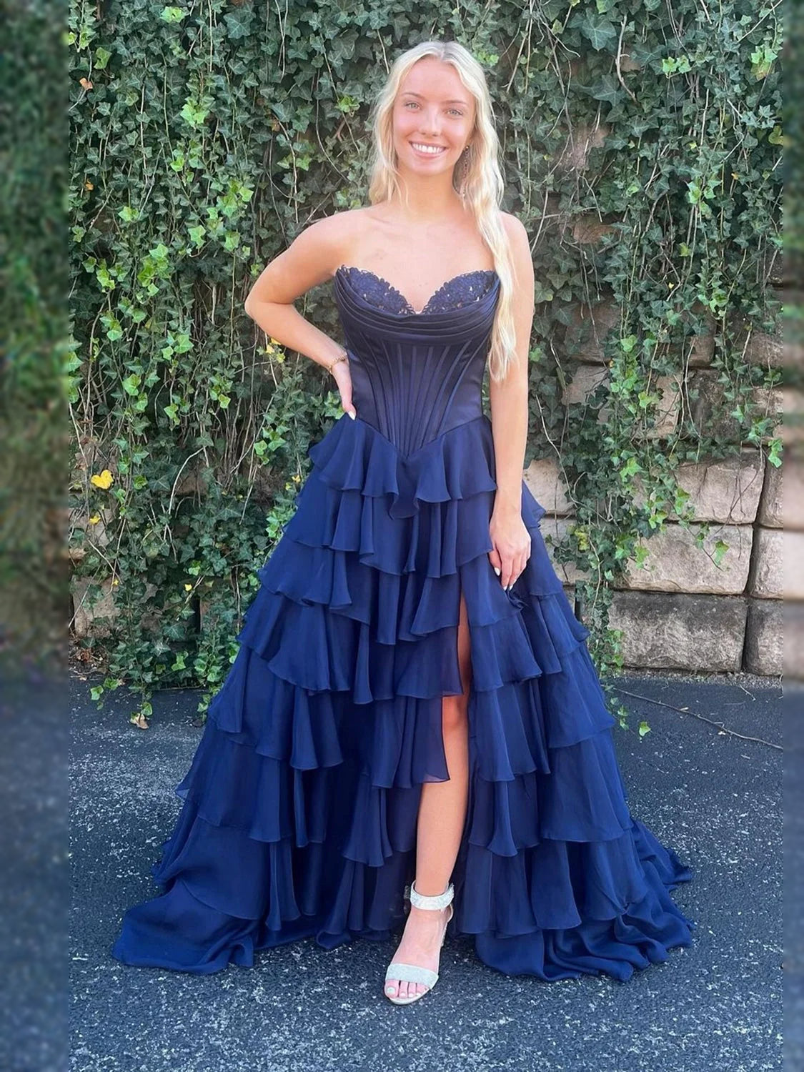 Navy strapless corset prom dress with tiered ruffle skirt, floor-length.