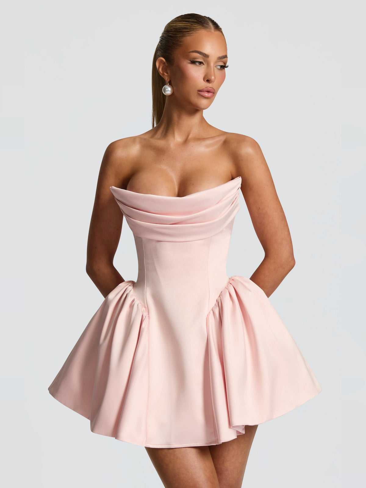 Blush strapless mini dress with draped neckline and gathered skirt panels