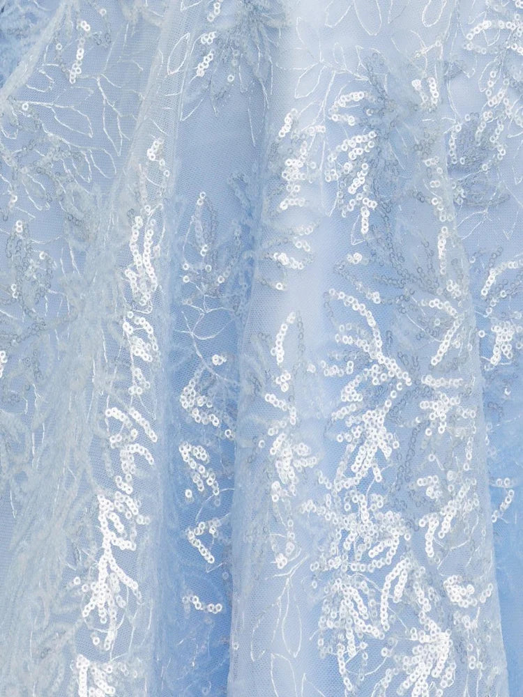 Close-up of light blue sequin and floral lace fabric on a corset mini dress
