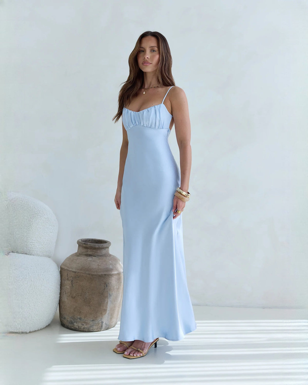 Light blue satin maxi bridesmaid dress with slim straps and flowing A-line skirt