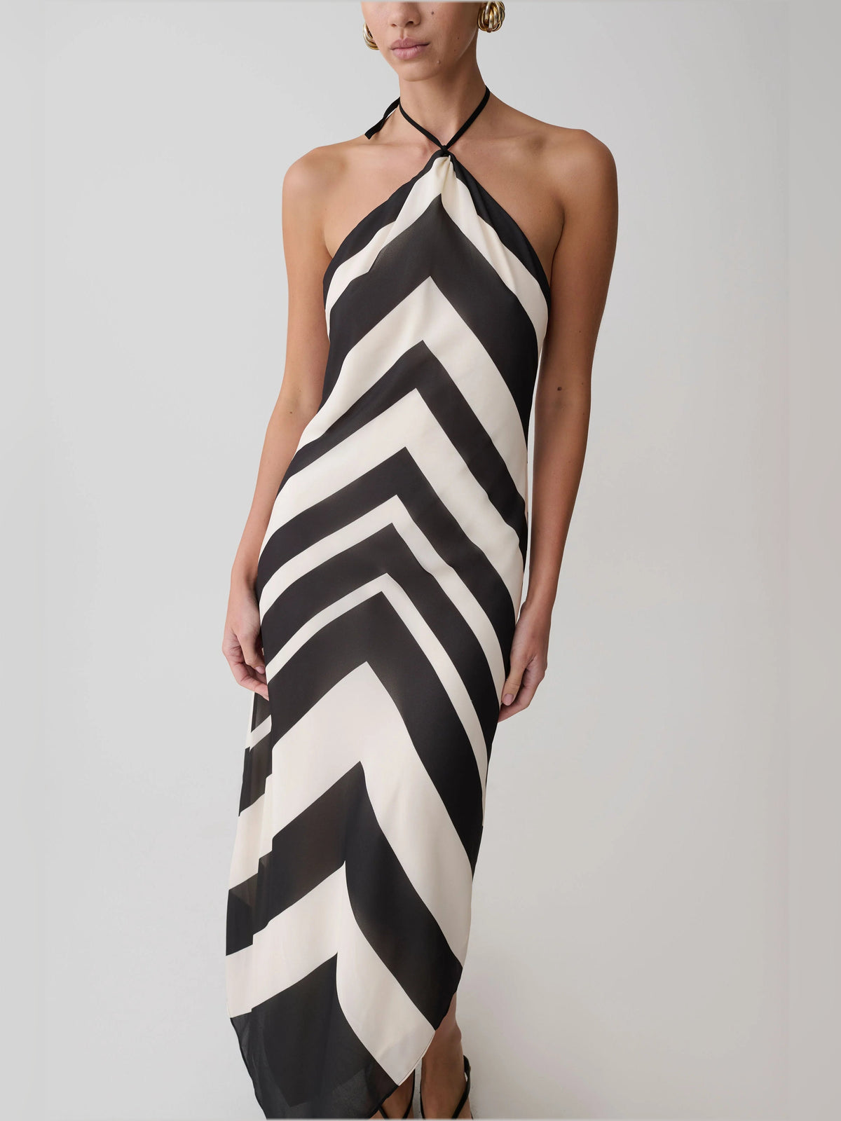 Front view of halter midi formal dress with black-and-white chevron zigzag and side drape.
