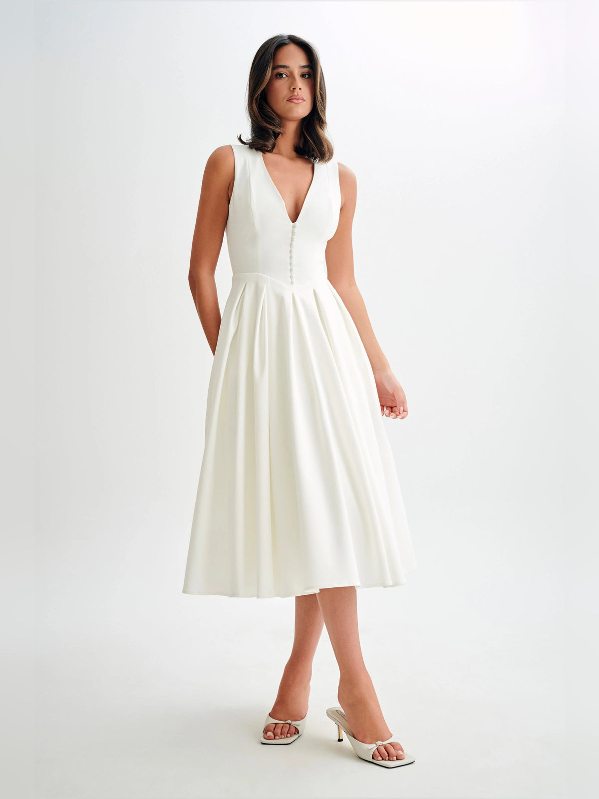 White sleeveless midi formal dress, fitted V-neck bodice with pleated skirt