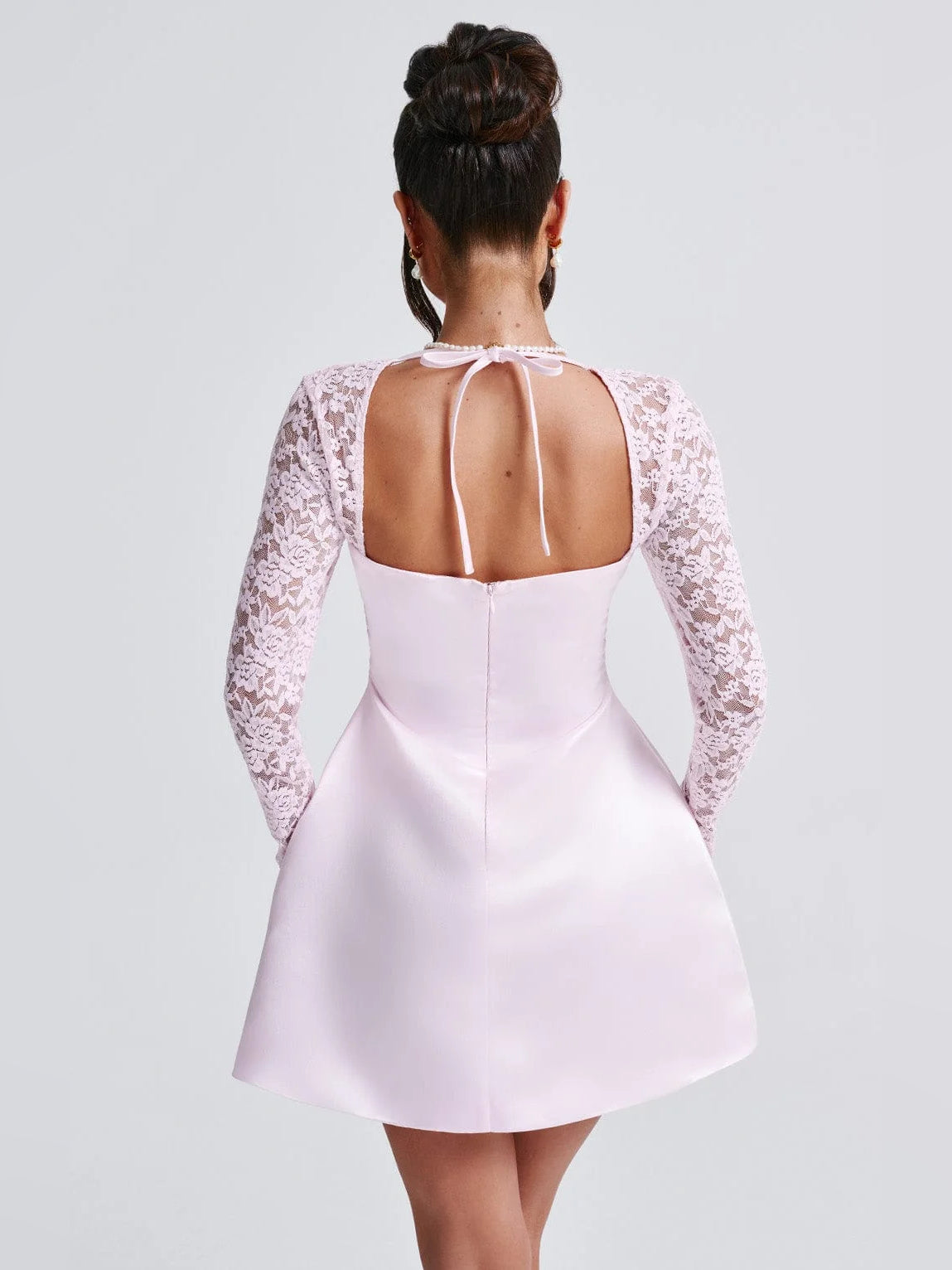 Blush satin mini dress with lace long sleeves and open-back keyhole detail
