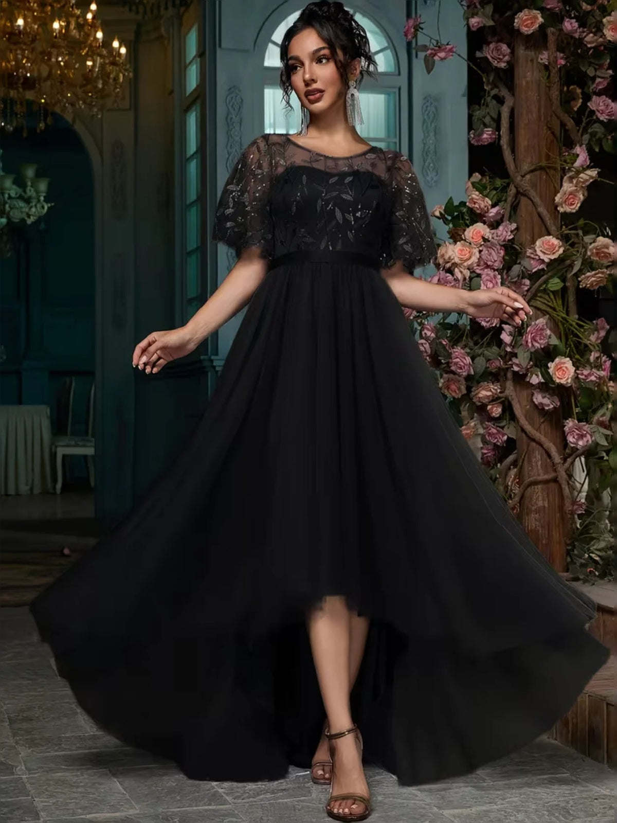 Black A-line maxi prom dress with embroidered bodice, short ruffled sleeves, and airy tulle skirt.