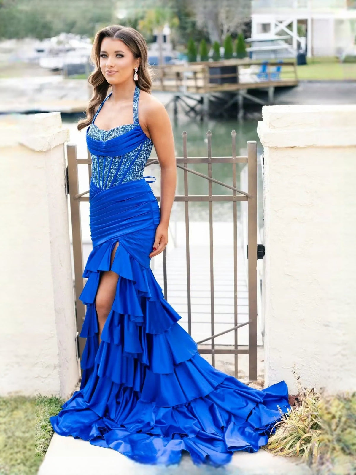 Cobalt blue halter mermaid prom dress with ruffled skirt and flowing train