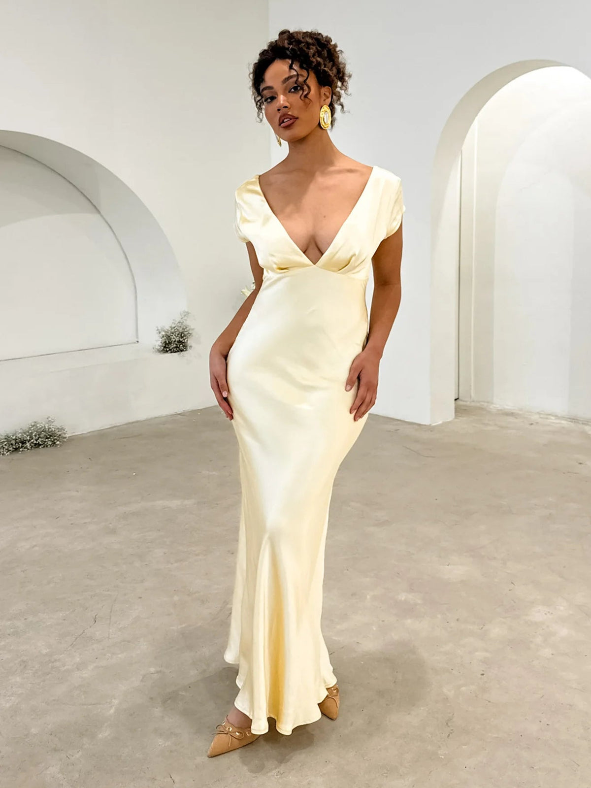 Yellow midi dress from side view with V-neck and twist back