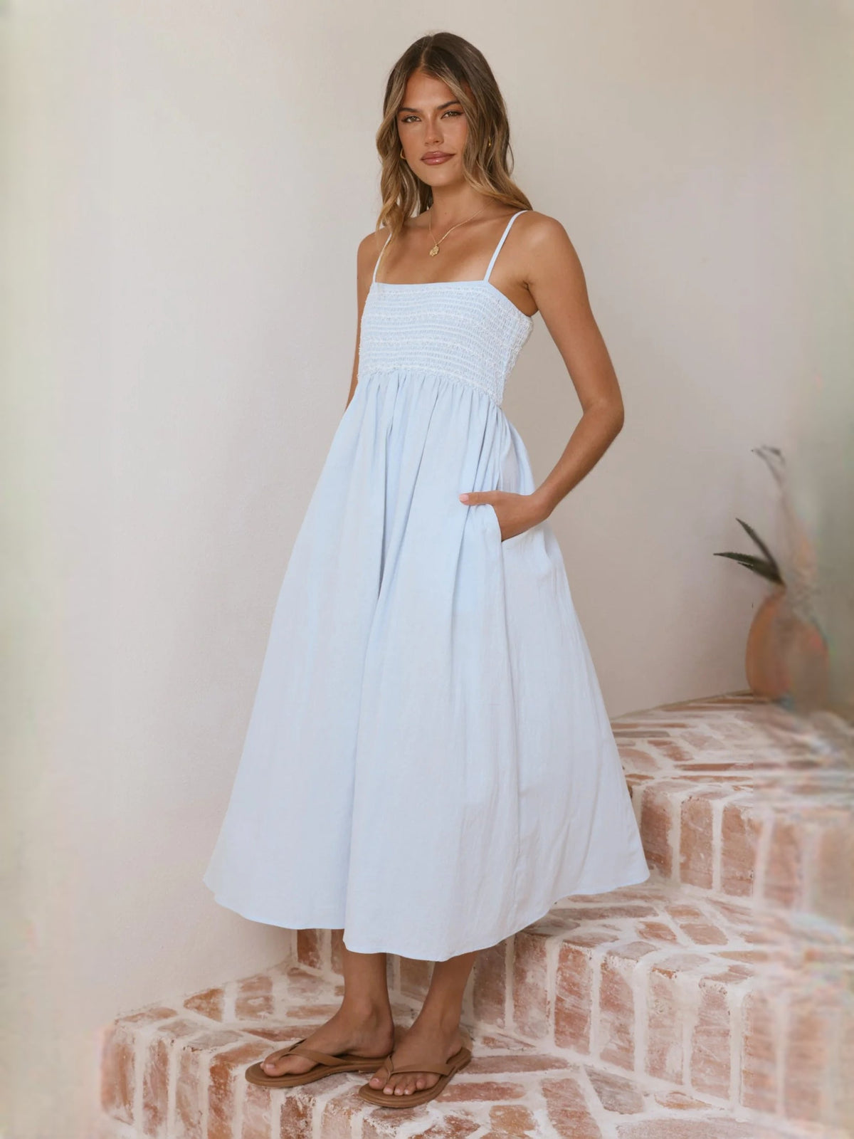 Light blue midi dress with spaghetti straps and smocked bodice, full skirt