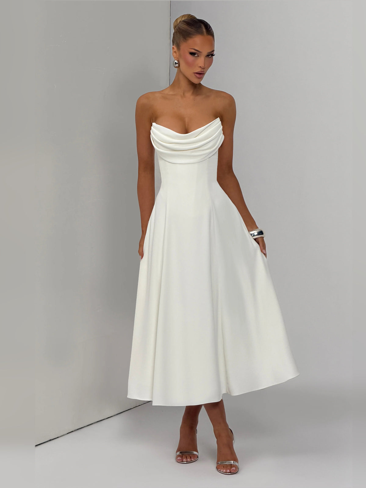 Ivory strapless midi formal dress, side view with flowing flared skirt