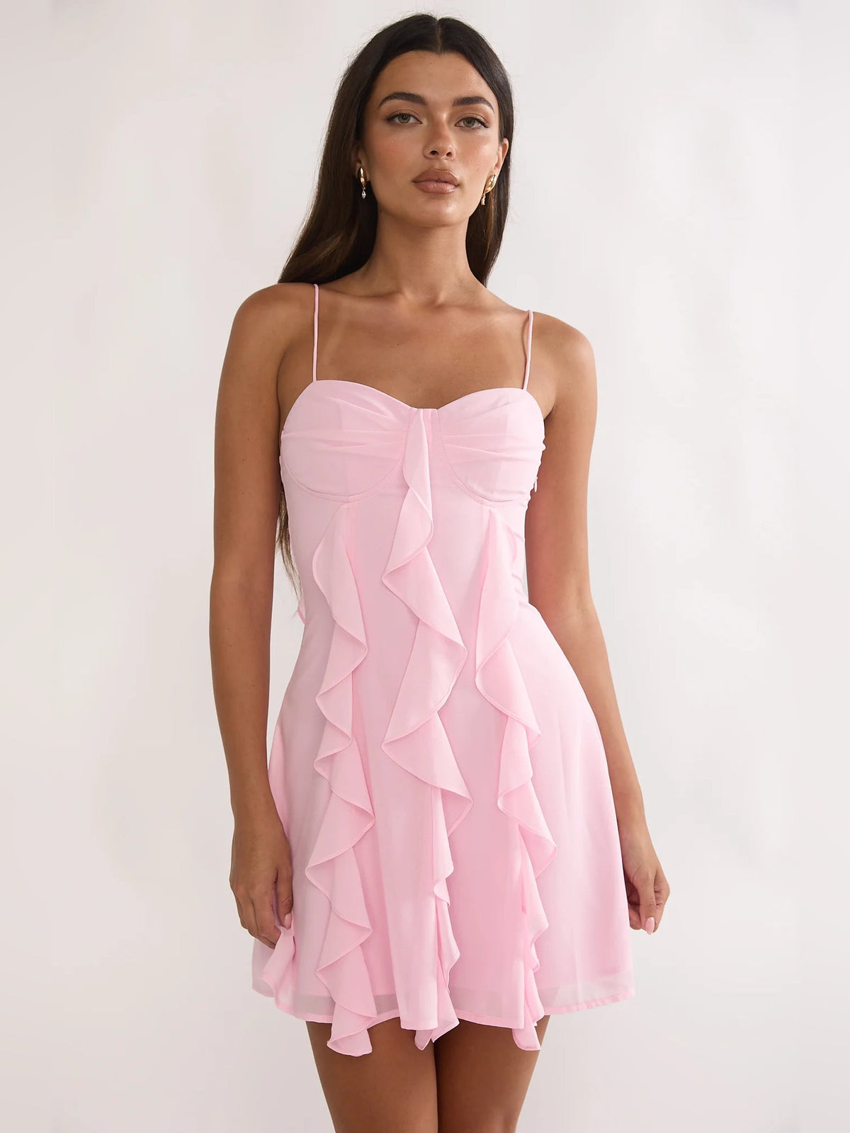 Blush pink ruffled mini dress with sweetheart bodice and spaghetti straps, tiered skirt