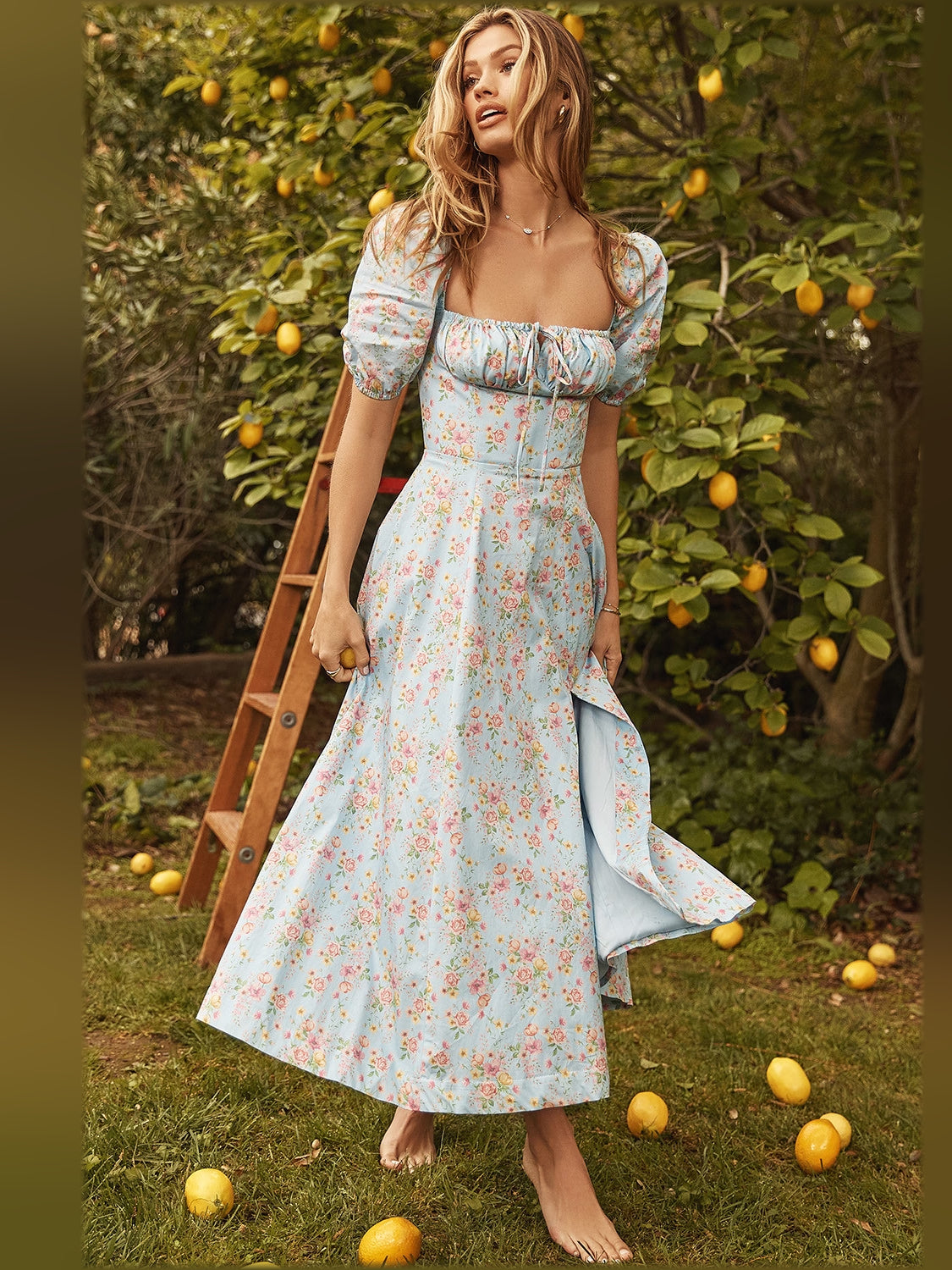 Light blue floral midi dress with puff sleeves, square neckline, and gathered waist seam