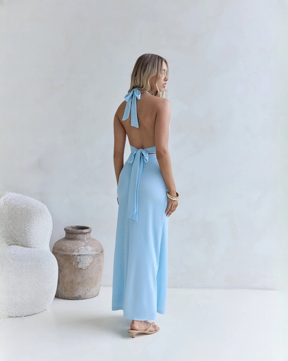 Light blue halter neck A-line maxi bridesmaid dress, back view with tied neck bow