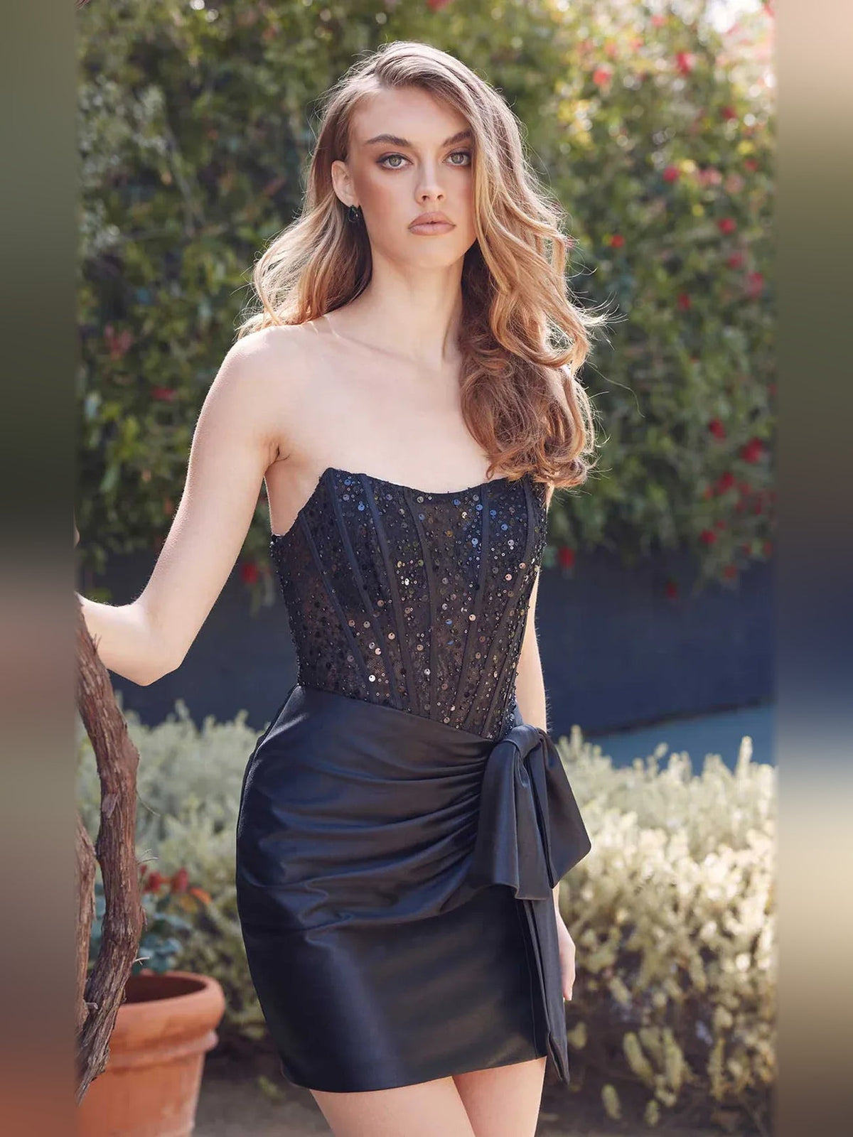 Black satin mini dress with strapless beaded bodice and draped waist bow detail