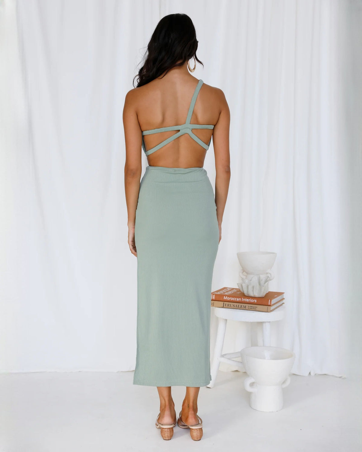 Sage green open-back maxi dress with crisscross straps and draped waist cutout