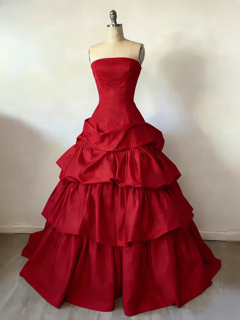 Red satin strapless corset ball gown with tiered ruffle skirt on mannequin