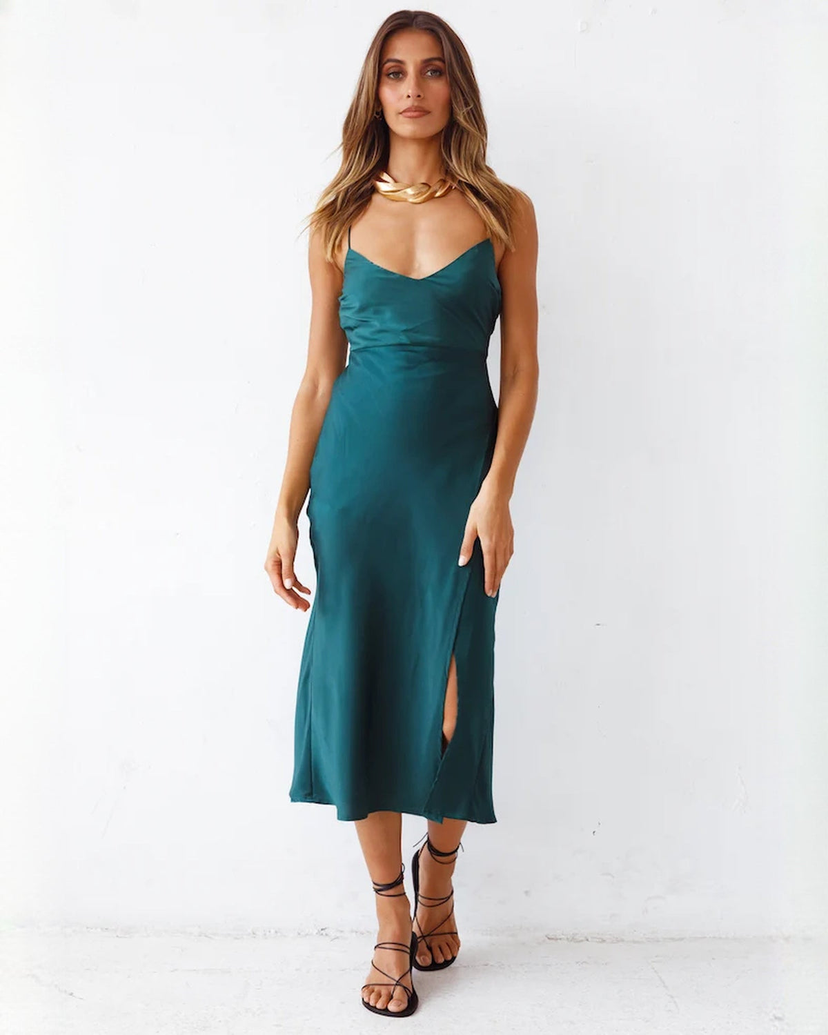 Deep teal satin midi dress with spaghetti straps, V-neck and tapered A-line skirt