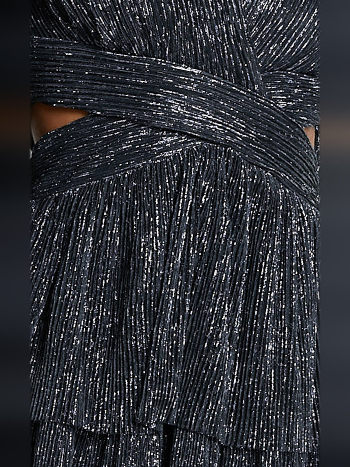 Black glittery fabric on long-sleeve dress, showing tiered ruffle layers