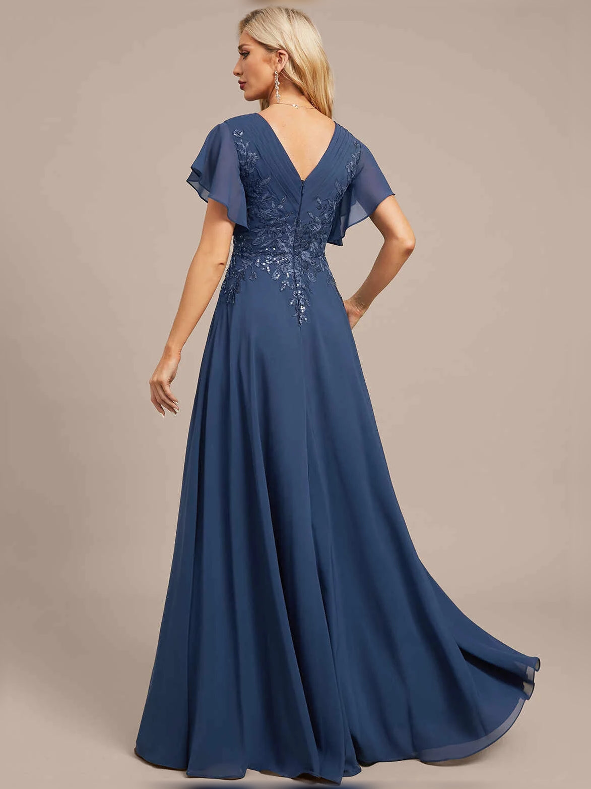 Blue V-neck A-line maxi dress, back-to-side view, with floral embroidery on bodice.