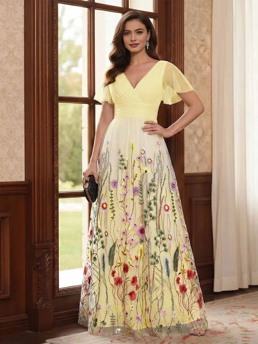 Pale yellow V-neck A-line tulle dress with ruched waist, short sleeves, and floral embroidery