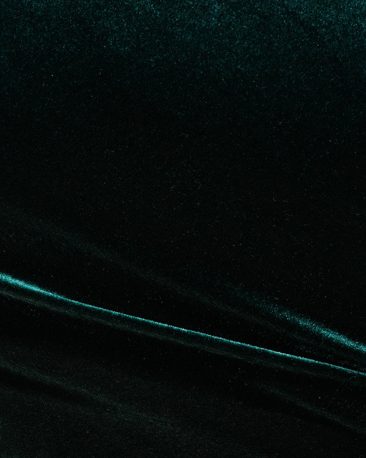 Hunter green velvet-like fabric texture with subtle sheen