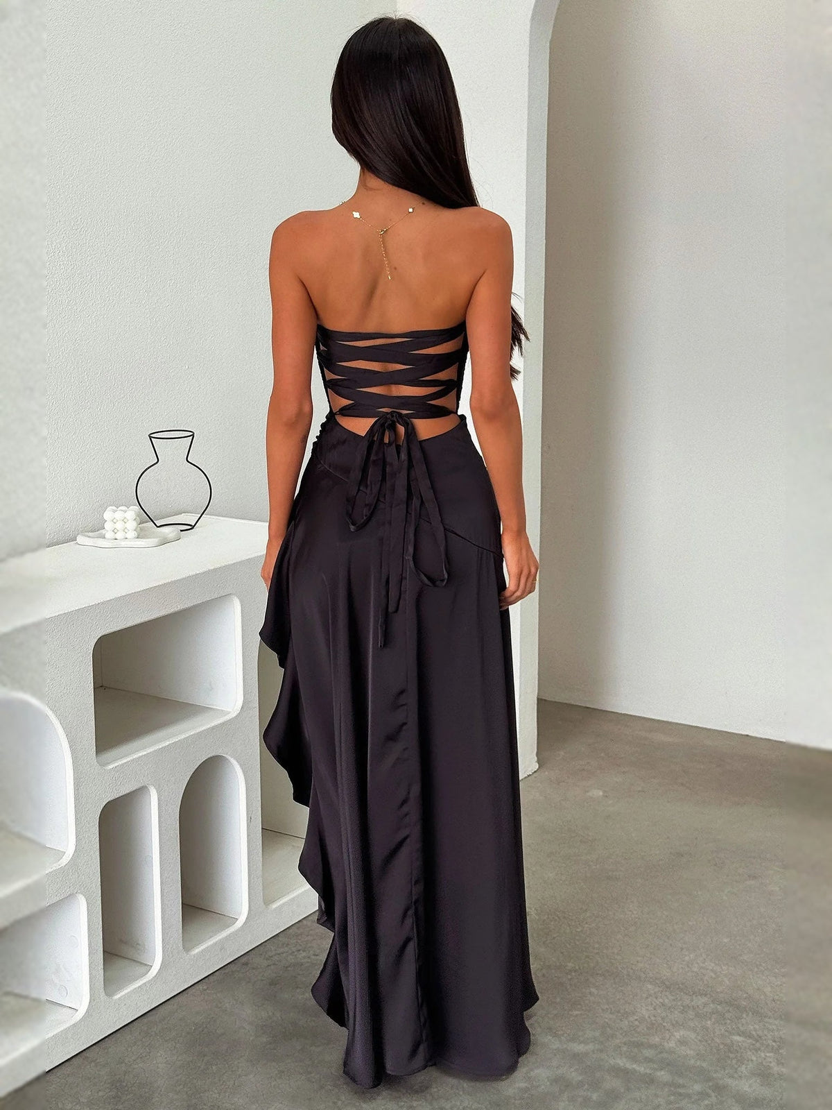 Black satin prom dress with crisscross lace-up open back and ruffled A-line hem