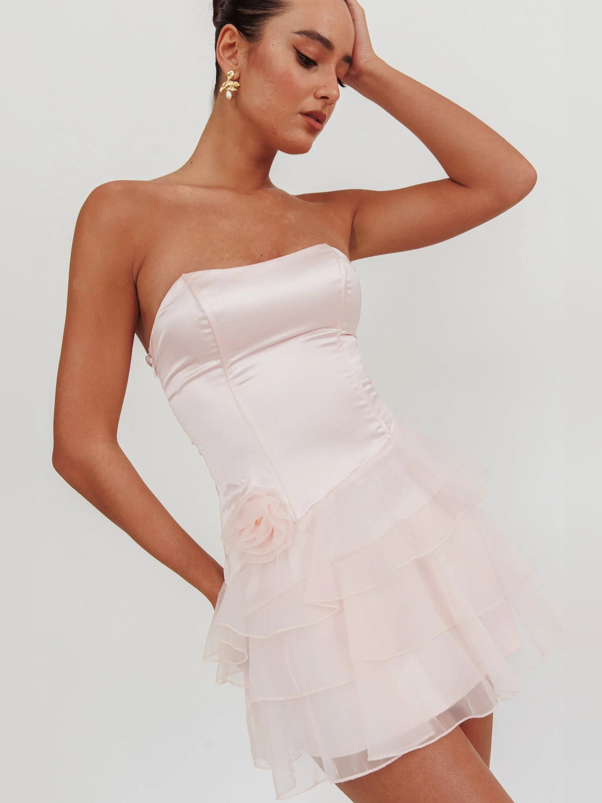 Blush strapless mini organza dress with tiered ruffle hem and rose detail at hip