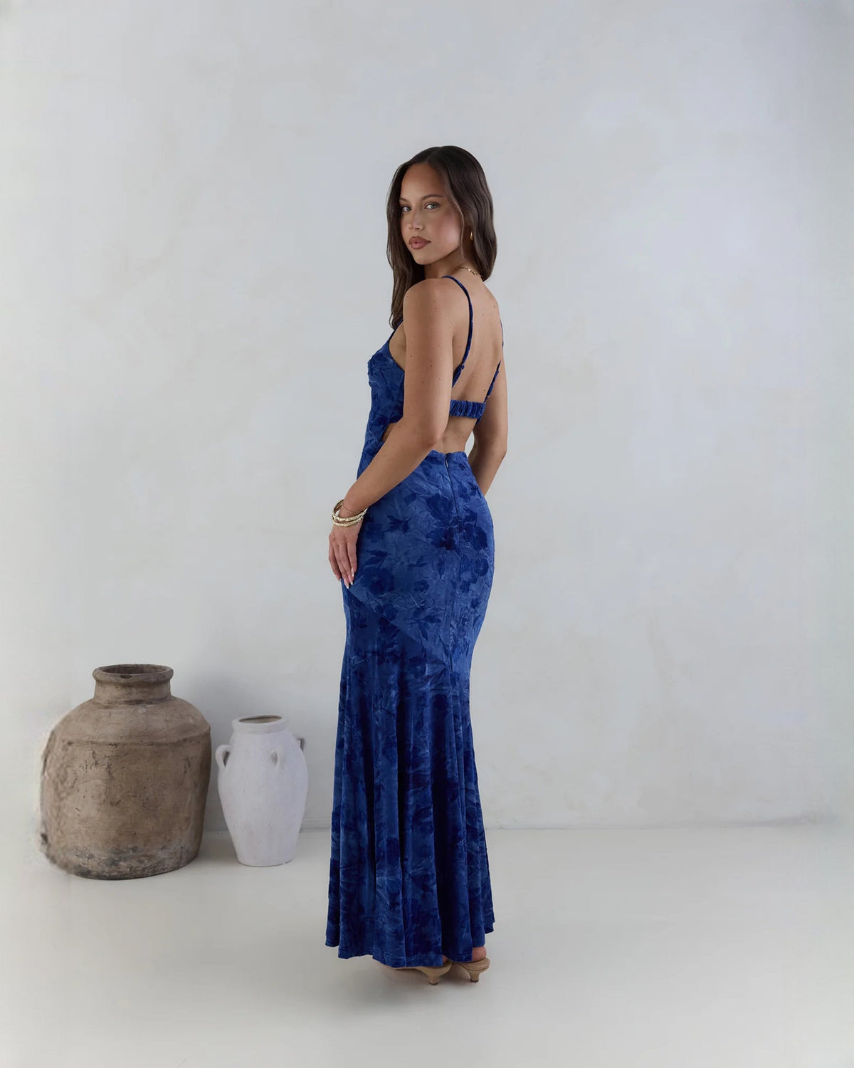 Navy sleeveless mesh maxi dress, side profile, spaghetti straps and A-line skirt.