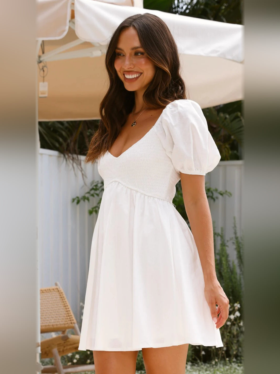 White mini homecoming dress with V-neck and puff sleeves, softly flared skirt