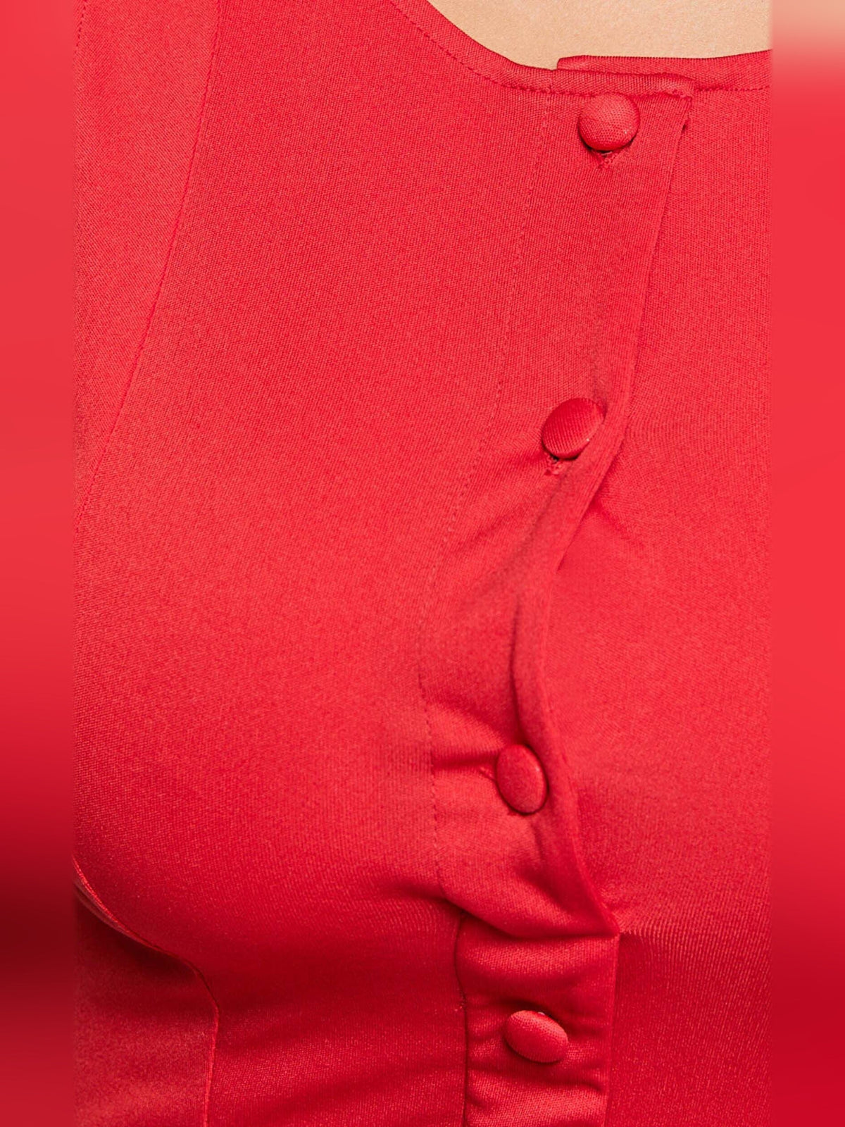 Red fabric close-up with round buttons and high-neck seam detail