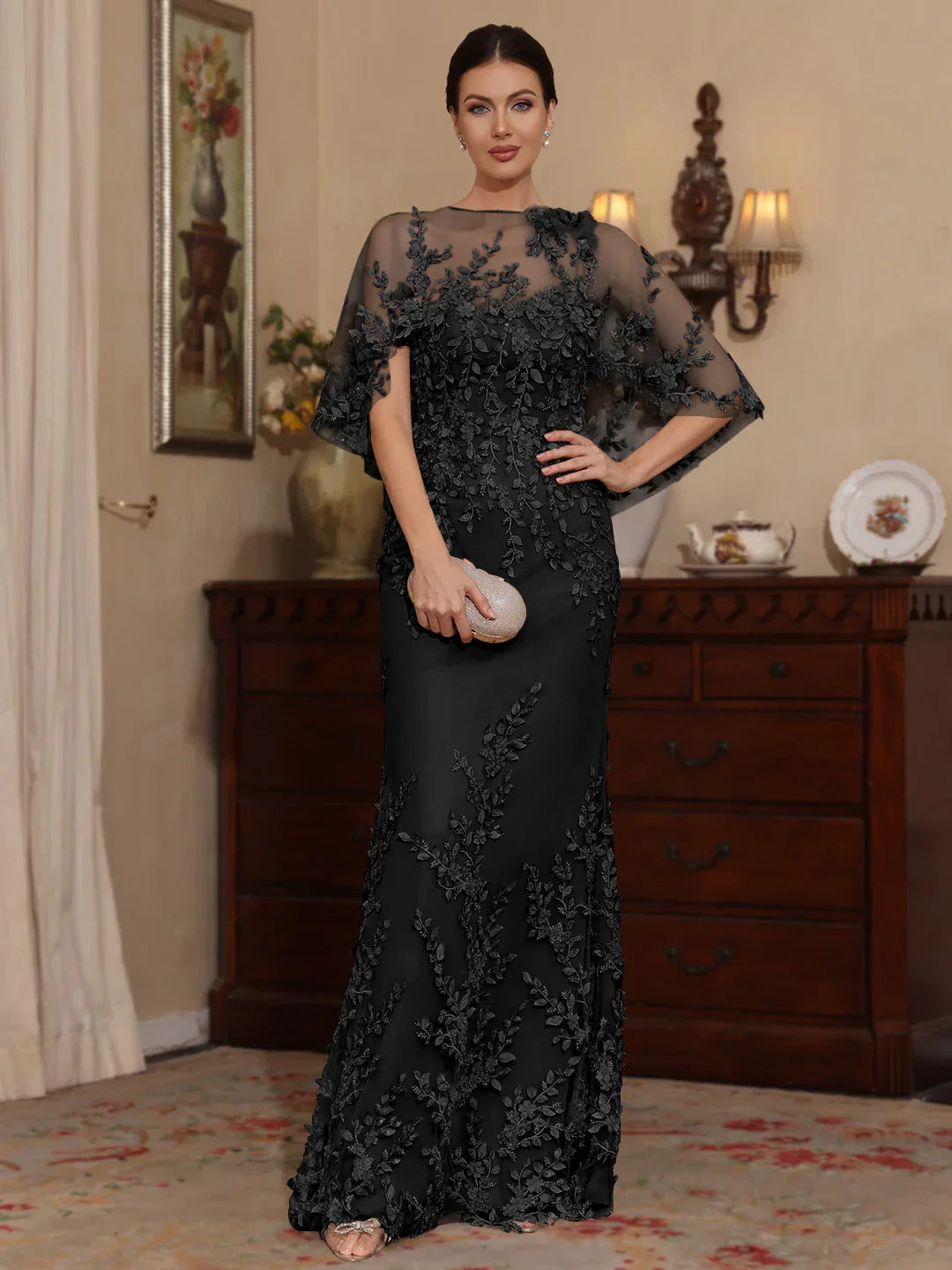 Black sweetheart mermaid mother-of-the-bride dress with floral appliques and cape sleeves