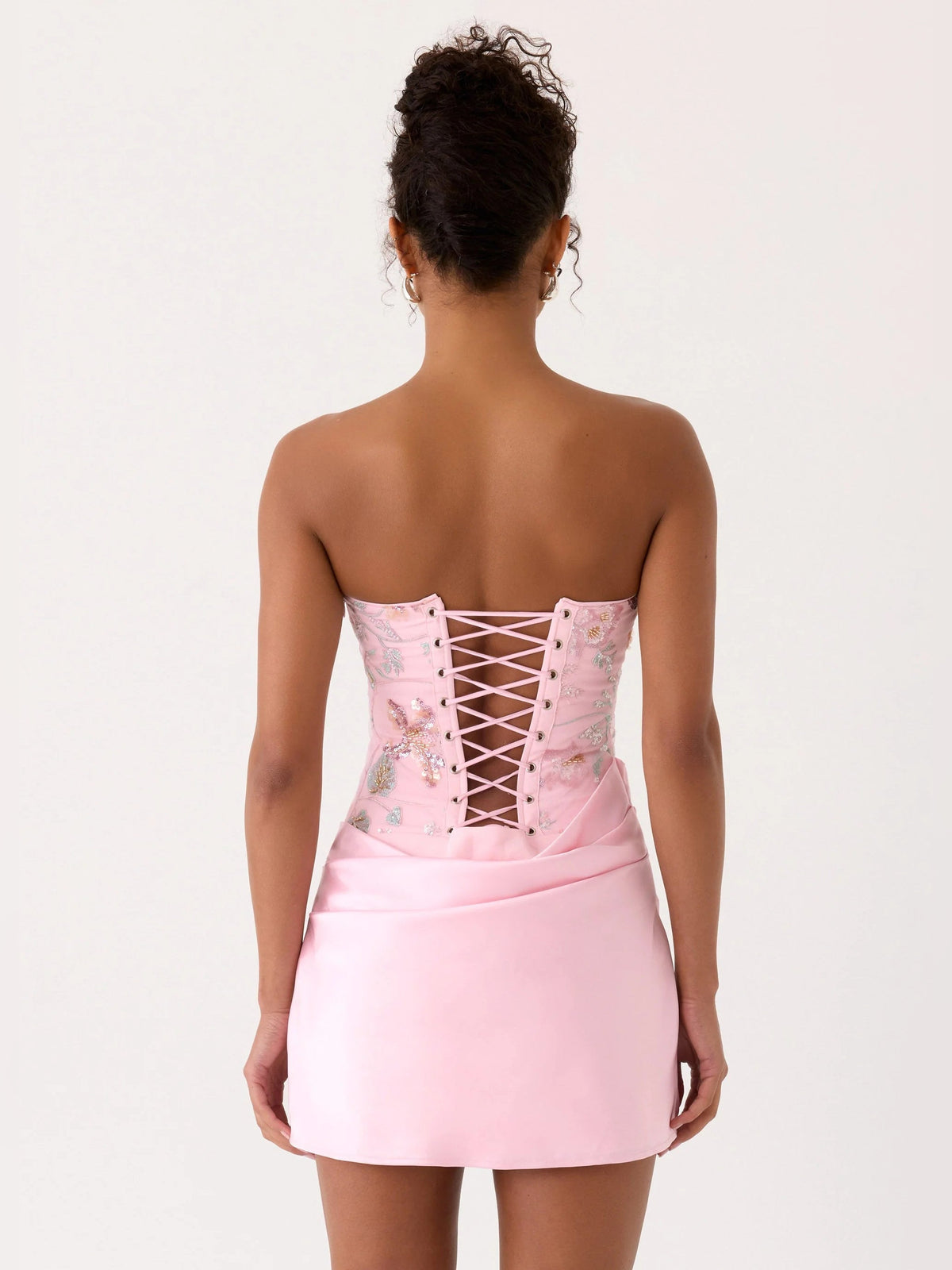 Pink strapless mini dress with cross-laced back and beaded floral bodice