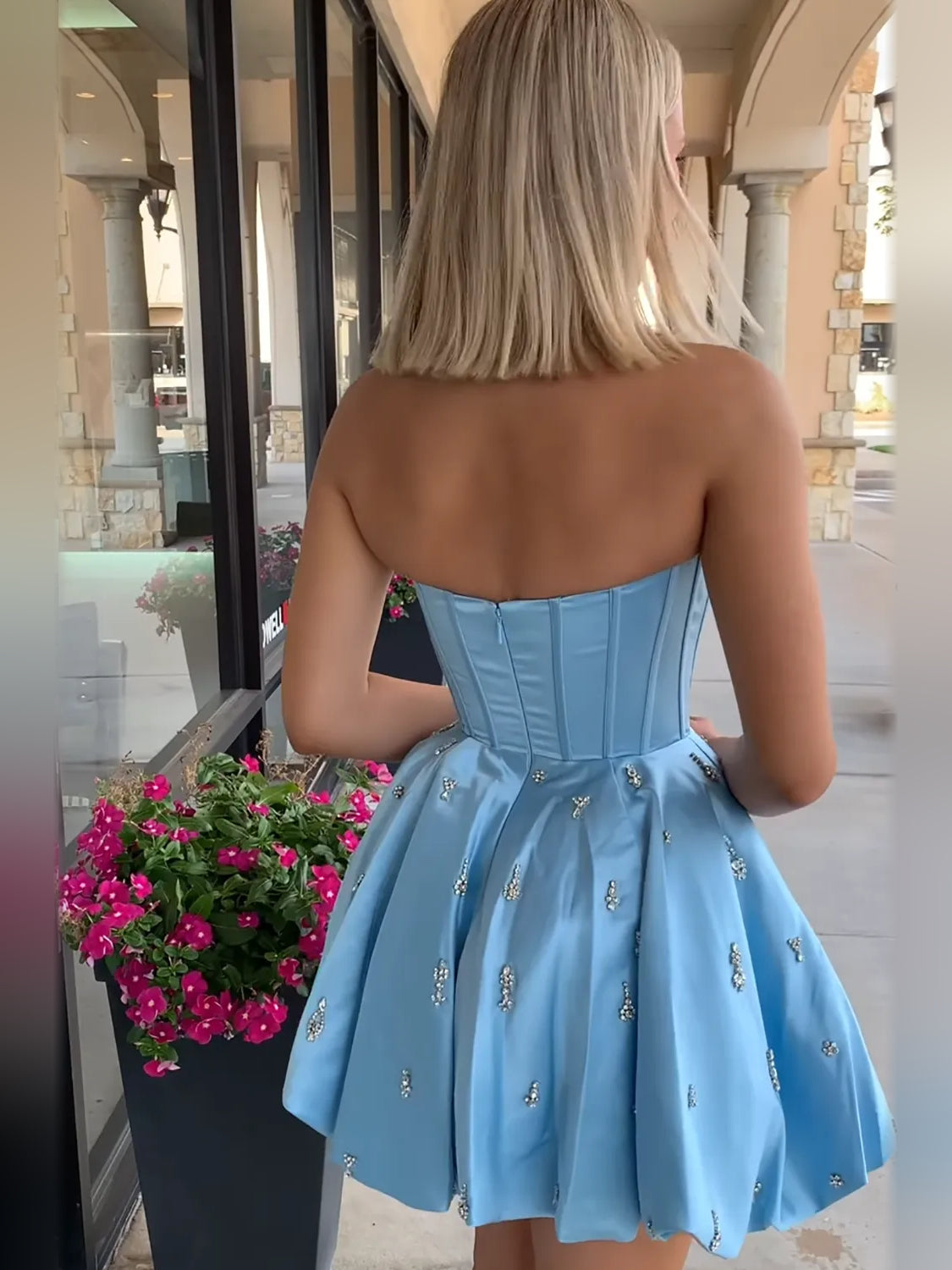 Blue satin A-line mini dress back view with corset-style waist and sparkling detail trim