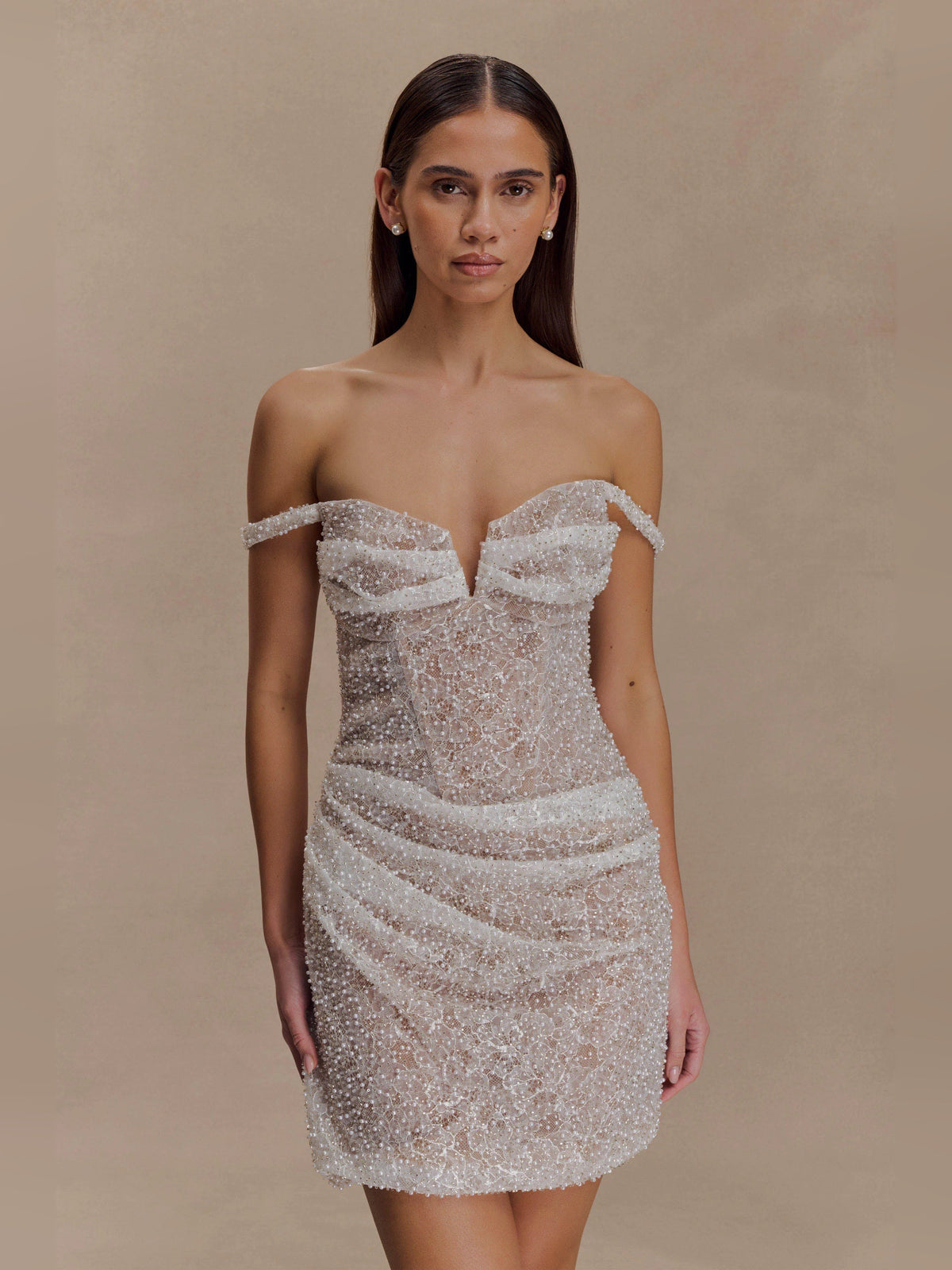 Front view of nude beaded off-shoulder bodycon mini dress with corset-like seams