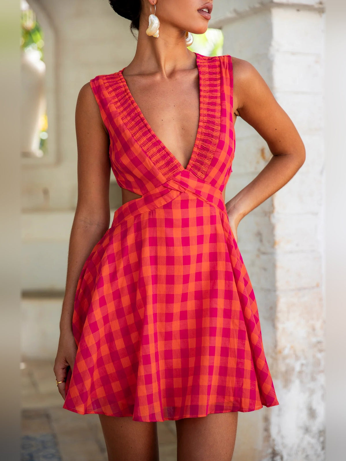 Pink and red gingham mini dress detail, deep V neckline and sleeveless bodice