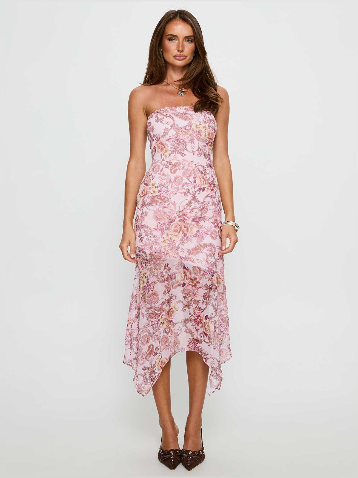 Pink floral paisley strapless midi dress with draped asymmetrical hem and fitted waist.
